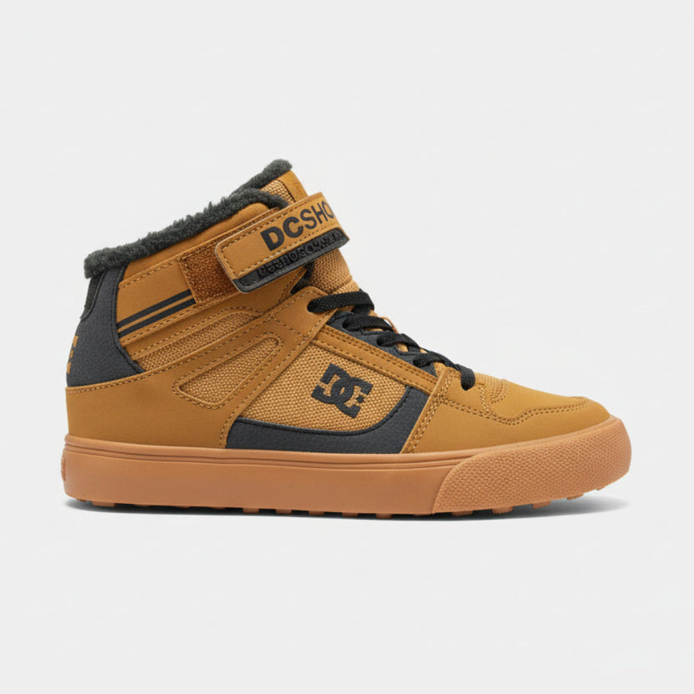 Tan sneaker with DC logo on a dark surface next to a branded box.
