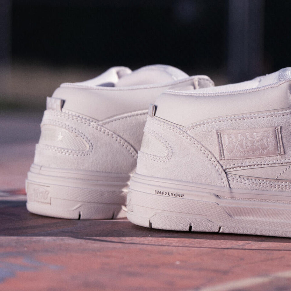 White sneakers on a brick surface with a blurred background